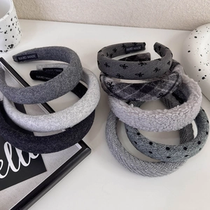 Detailed view of various grey knitted headbands with polka dots and bows in high quality