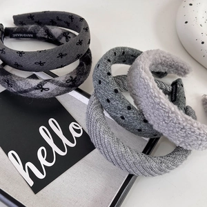 Detail of five grey headbands with polka dots and bows featuring a handmade inner label