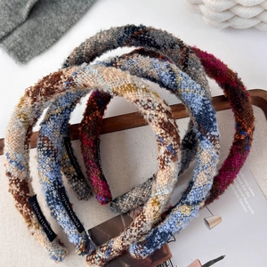 Handmade tweed headbands in various colors displayed on a tray for an elegant hair look