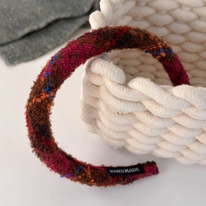 Macro shot of colorful tweed fabric texture and black Handmade label on headband