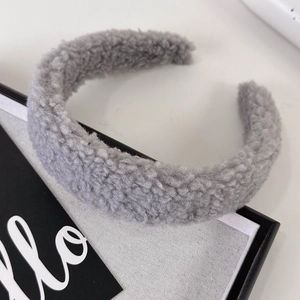 Detailed view of gray plush fabric headband with thick fleece texture and wide band style