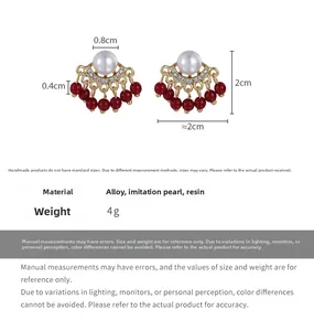 Detailed view of fan-shaped pearl earrings with red bead tassels and size specifications