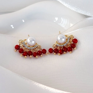 Elegant fan-shaped gold pearl earrings with red beads and sparkling tassels for women
