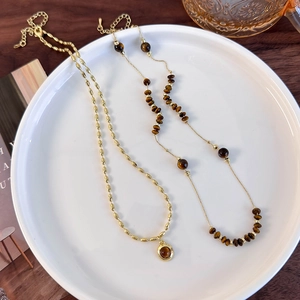 Double-layered tiger eye stone necklace with gold oval links and retro vintage style