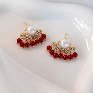 Elegant gold fan earrings with white pearls, red bead tassels and sparkling rhinestones