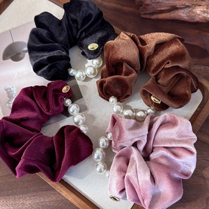 Elegant velvet scrunchies with white pearls and gold logo in four stylish colors