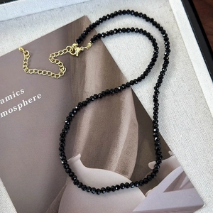 Minimalist black crystal and silver bead necklace with adjustable gold-tone lobster clasp