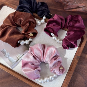 Elegant velvet pearl scrunchies in four classic colors for stylish ponytail styling