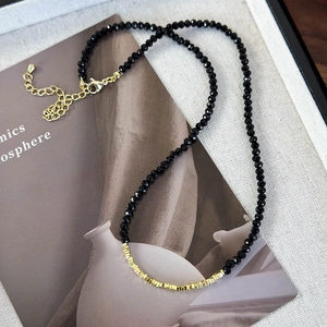 Minimalist black faceted bead necklace with gold square accents and lobster clasp closure