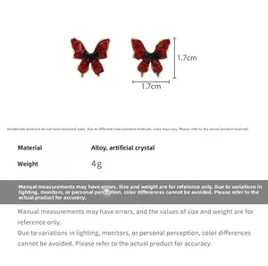 Detail view of red crystal butterfly earrings showing size dimensions 1.7cm by 1.7cm