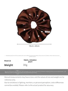 Detail of a brown velvet scrunchie with faux pearls and size specifications shown