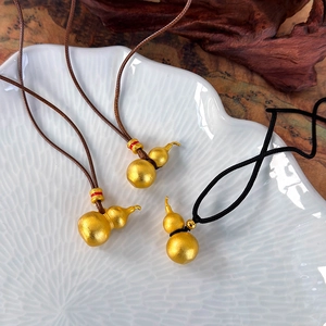 Matte gold gourd necklace with traditional Chinese style pendant on cord