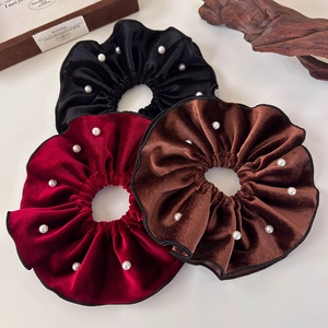 Three elegant velvet scrunchies with white pearls in black, burgundy and brown colors