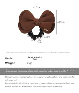 Detail view of coffee wool bow hair tie with elegant white pearls and pleated elastic band