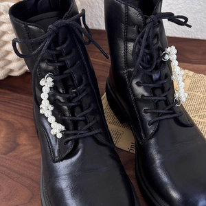 Black leather boots with white pearl shoe charms and thick non-slip rubber soles