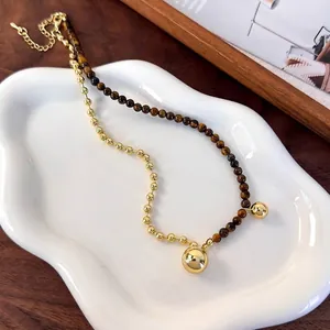 Elegant tiger eye and gold bead asymmetric necklace with spherical pendant detail