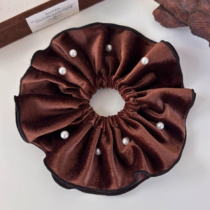 Macro shot of coffee brown velvet hair scrunchie with white pearl embellishments