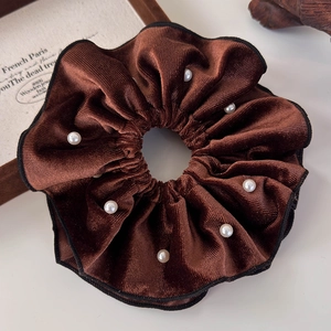 Detail shot of vintage dark brown velvet scrunchie with white pearls and black trim