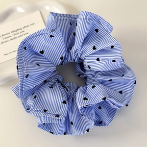 Detailed macro view of the blue striped heart pattern scrunchie with ruffled fabric texture
