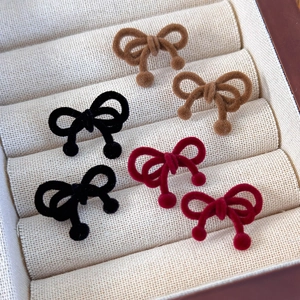 Vintage velvet bow earrings in brown, black, and wine red colors displayed in a gift box