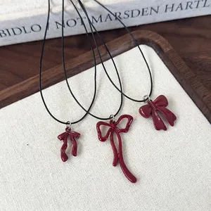 Three burgundy bow pendant necklaces on black wax cord with French vintage style