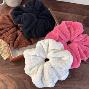 Set of four oversized plush scrunchies in black, coffee, rose pink, and cream white colors