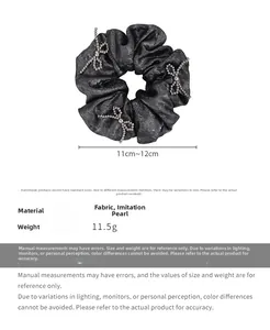 Detail of black silk hair scrunchie with pearl bow decor, size 11cm and weight 11.5g