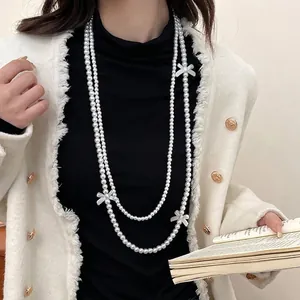 Elegant double-layered pearl necklace with bows shown on a model in vintage style