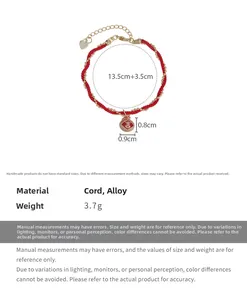 Macro shot of handmade red rope bracelet with golden lucky charm and size dimensions