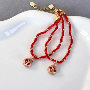 Handmade red cord bracelet set with gold lucky bag charms and heart pendants