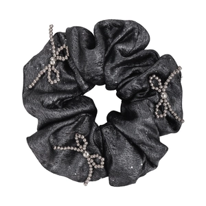 Sparkly black scrunchie with silver beaded bow accents for elegant hairstyles