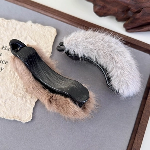 Detailed view of plush banana clips in brown and grey faux fur for autumn winter hair styling