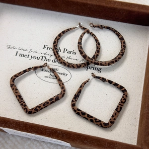Macro shot of vintage leopard print flocking geometric round and square earrings