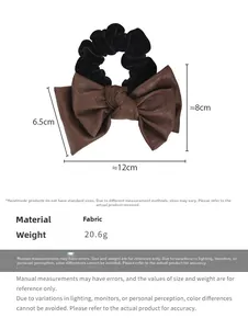 Detail view of retro bow hair tie showing 12cm width dimensions and brown leather texture