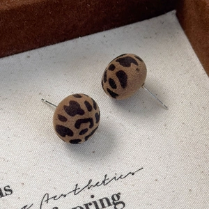Close-up of vintage flocking leopard print ball stud earrings with soft suede texture