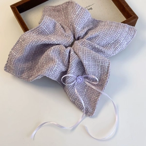 Close-up of elegant purple tweed scrunchie with silk ribbon bow and decorative button