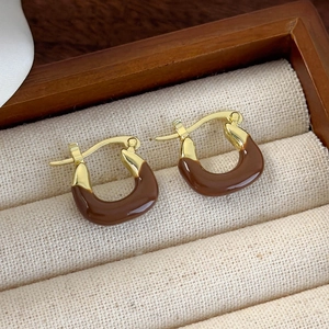 Brown enamel hoop earrings with golden metal finish in a minimalist urban style design