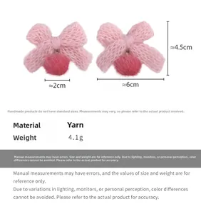 Detailed view of pink yarn bow earrings with magenta pom-pom drops and 4.5cm size markers