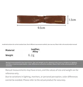 Detail of dark brown leather bow clip with 9.5cm length and stitched edge texture