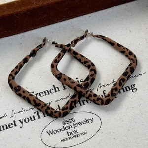 Detailed view of large square leopard print earrings with a vintage velvet finish