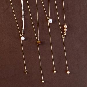 Elegant adjustable long Y-shape gold necklace with pearls and tiger eye stone accents