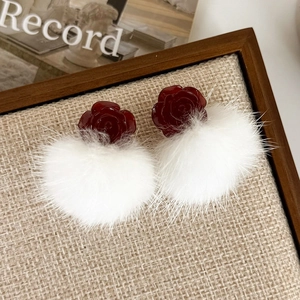 Detailed close-up of vintage red rose resin stud with a soft white plush pompom
