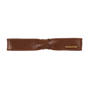 Brown faux leather bow hair clip with glossy finish and gold logo for women fashion