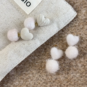 Winter heart knit earrings with plush faux fur pompom charms for a cozy autumn look