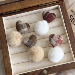 Brown plaid fabric heart and pom-pom earrings set displayed in a wooden jewelry box