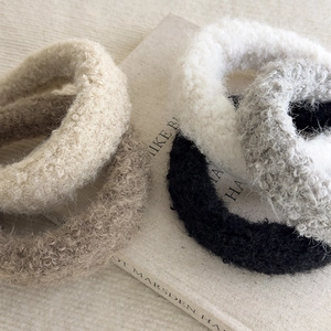 Fuzzy faux shearling scrunchies in neutral colors for autumn and winter hairstyles