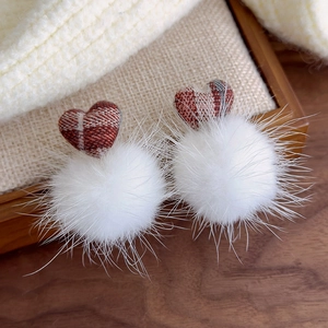 Detailed view of plush white pom-pom earrings with brown plaid heart charms for women