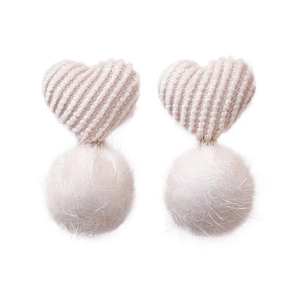 Winter heart-shaped knit earrings with fluffy white fur pom poms on a plain white background