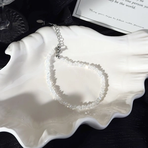 Detail of natural white crystal beads with silver extension chain and lobster clasp