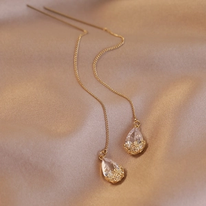 Elegant gold drop earrings with white teardrop zircon and delicate flower charms on silk